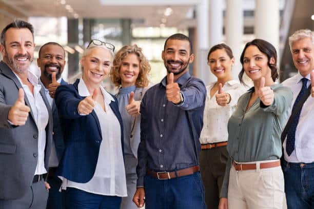 Group of successful business people showing thumbs up Group of happy multiethnic business people showing sign of success. Successful business team showing thumbs up and looking at camera. Portrait of smiling businessmen and businesswomen cheering at office. Employee Engagement And Satisfaction stock pictures, royalty-free photos & images